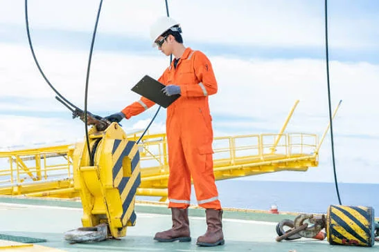 Technician inspecting lifting equipment